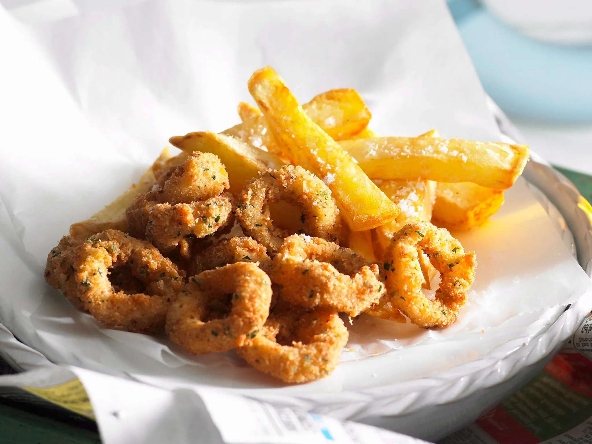 Crispy squid rings and hot chips on butcher's paper