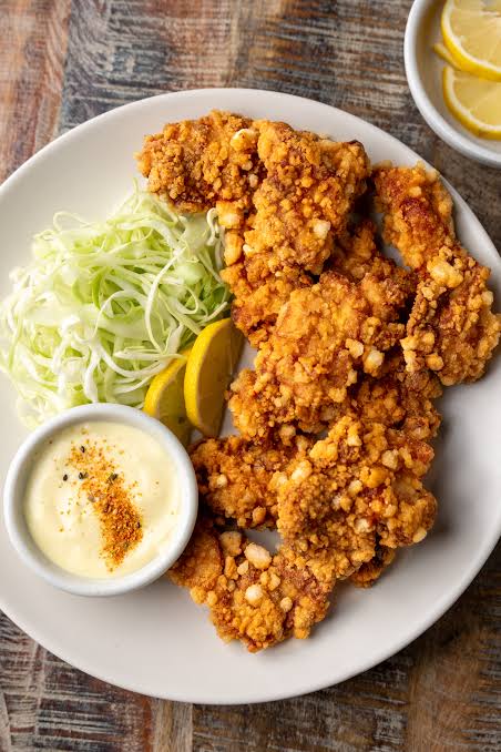 Karaage fried chicken over hot chips with mayo drizzle